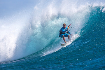 Kite surfer rides among the huge tubes and waves of the Indian Ocean on the island of Mauritius