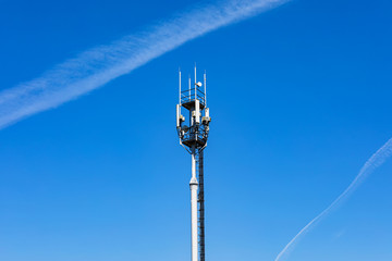 Telecommunications tower with 4G, 5G transmitters. cellular base station with transmitting antennas...