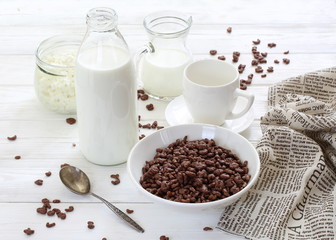 Milk is poured into chocolate balls.
Breakfast cereal