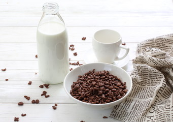 Milk is poured into chocolate balls.
Breakfast cereal