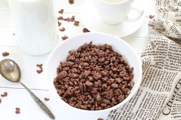 Milk is poured into chocolate balls.
Breakfast cereal
