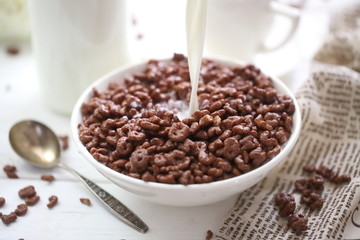 Milk is poured into chocolate balls.
Breakfast cereal
