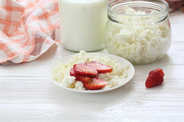 Cottage cheese with strawberries on a white background