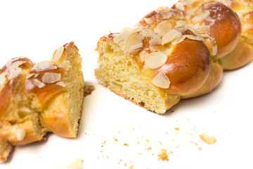 Closeup of braided almonds cake on white background