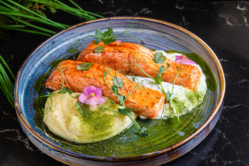 Fresh salmon fish dish with mashed potatoes and yogurt dressing