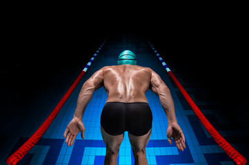 Portrait of a swimmer on the background of a sports arena. The concept of swimming and water games....