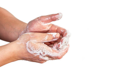 Young man wash hands with soap, closeup detail on soap bubbles, isolated on white, space for text right side. Can be used during coronavirus covid-19 outbreak prevention