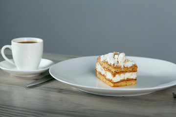 cake on the plate and cup of coffee
