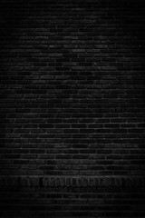 Fototapeta na wymiar Black brick walls that are not plastered background and texture. The texture of the brick is black. Background vertical of empty brick basement wall.