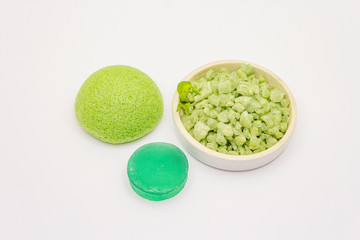 Sea salt, green tea soap and sponge isolated on white background