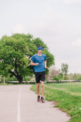 Obraz premium young guy runs morning stadium workout