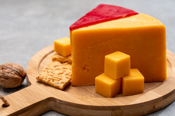 Matured yellow and red waxed cheddar cheese close up