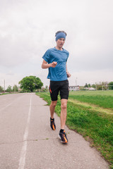 young guy runs morning stadium workout