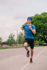 young guy runs morning stadium workout