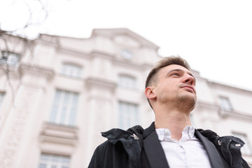 Handsome young man is walking in town