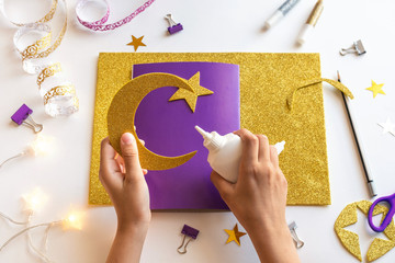 4 Diy Ramadan kareem card with golden crescent moon and a star. Gift idea, decor Ramadan kareem. Step by step. Top view. Process kid children craft. Workshop. © mayanko