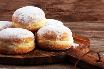 German donuts with jam and icing sugar. Carnival powdered sugar raised donuts for party