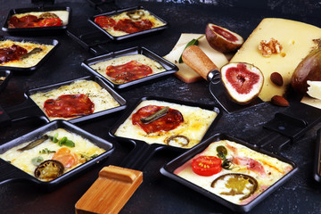 Delicious traditional Swiss melted raclette cheese on diced boiled or baked potato.