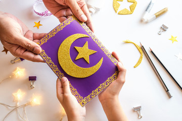 Diy Ramadan kareem card with golden crescent moon and a star. Gift idea, decor Ramadan kareem. Step by step. Top view. Process kid children craft. Workshop.