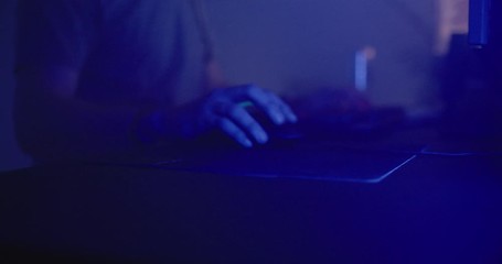 Man playing video games at night