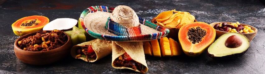 Mexican food mix in colorful colors. sombrero and mexican food with tacos