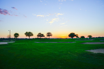 Aerial view of a golf course at sun set
