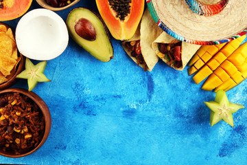 Mexican food mix in colorful colors. sombrero and mexican food with tacos