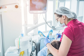 The dentist examines a patient at a reception in the dental office. The concept of health care and treatment in medical facilities