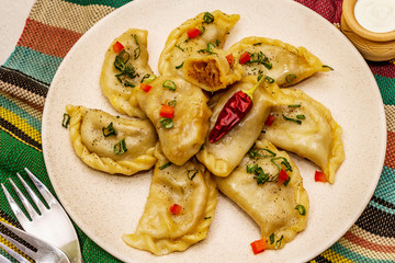 Dumplings stuffed stewed cabbage and sour cream. Traditional Ukrainian dish varenyky