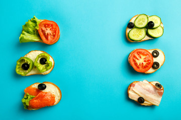 Set of assorted sandwiches on a blue background.
