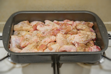 Fresh appetizing chicken wings fried on a kitchen gas stove
