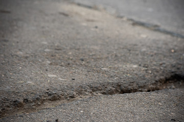Horizontal crack in the old asphalt canvas