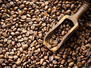 Lots of brown coffee beans, close-up. There is a place for the text.