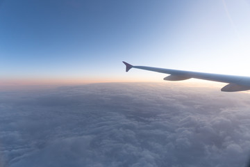 Fototapeta na wymiar over the clouds in a plane