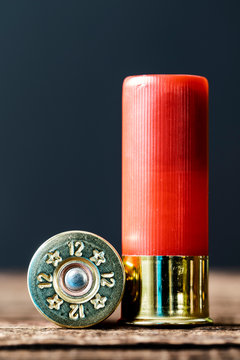 Selective approach of 12-gauge shotgun cartridges used for hunting, on a wooden table