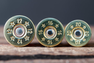 Selective targeting of 12,16 and 20-gauge shotgun cartridges used for hunting, on a wooden table