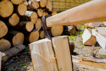Chopping wood with vintage axe. Frozen moment.