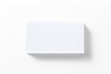 Blank letterpress business cards stack isolated on white high view as template for design presentation, logo embossing, mock-up etc.