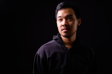 Obraz premium Face of young Asian man with hoodie thinking