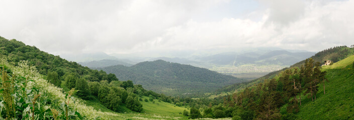 Fototapeta na wymiar Mountain landscape panoramik of Georgia on sunny day, blue cloud sky