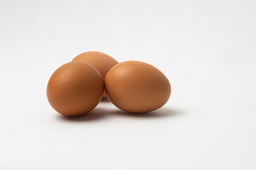 Three chicken eggs on a white background