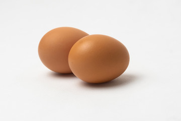 Two chicken eggs on a white background