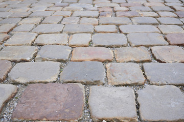 Historic cobblestones photographed obliquely as a background