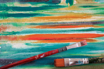 Close up of two dirty artistic brushes on oil painting on canvas, art jute, texture pattern for vivid background