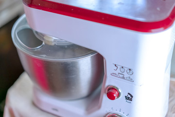 The mixer whips the dough to prepare it for baking.