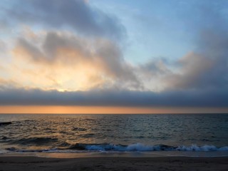Fototapeta na wymiar Spring cloudy sunrise on Black sea, public beach in Odesa, Ukraine