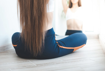 Close up of yoga woman sitting in lotus position at home on the terrace. a girl of European...