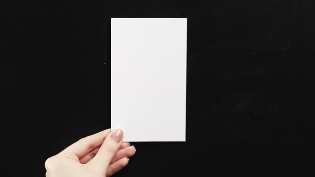 Set of 2 templates. Advertising card mockup. Woman hand holding white empty paper with copyspace on black.