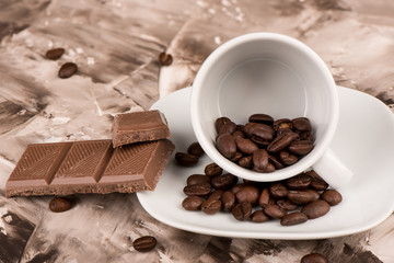 Close up. Coffee beans in a coffee cup and saucer.