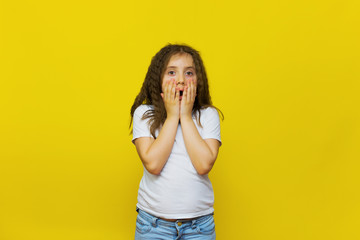 Beautiful little fashion model on Yellow studio background.